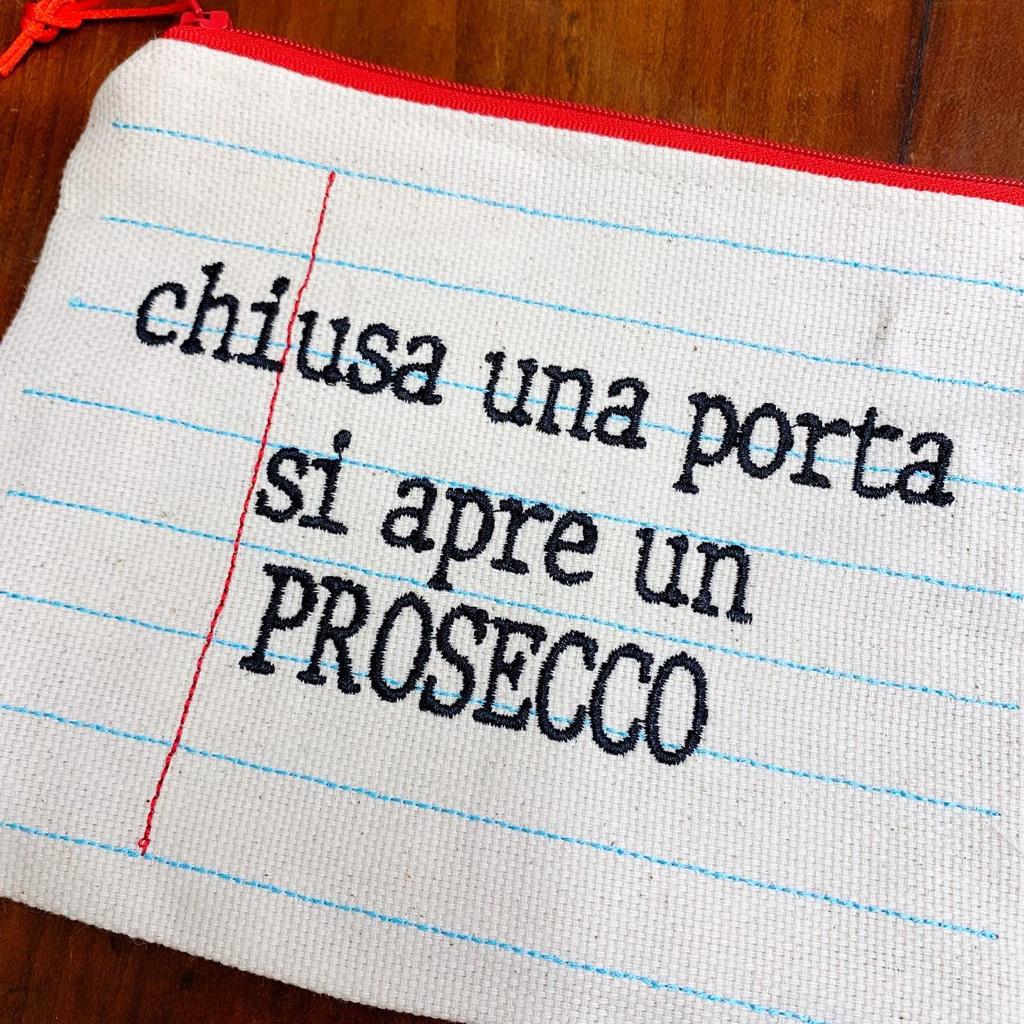 Pochette ricamata quaderno "chiusa una porta si apre un proseco"