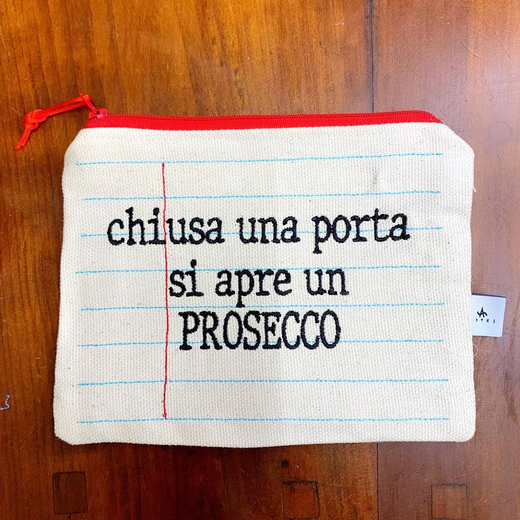 Pochette ricamata quaderno "chiusa una porta si apre un proseco"